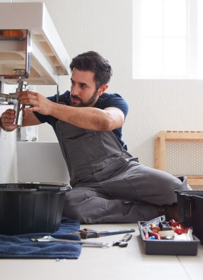 male-plumber-working-to-fix-leaking-sink-in-home-.jpg male-plumber-working-to-fix-leaking-sink-in-home-.jpg